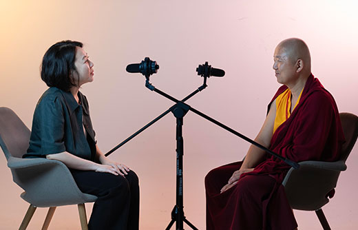 A-photo-of-a-woman-interviewing-a-monk-with-dramatic-lighting.